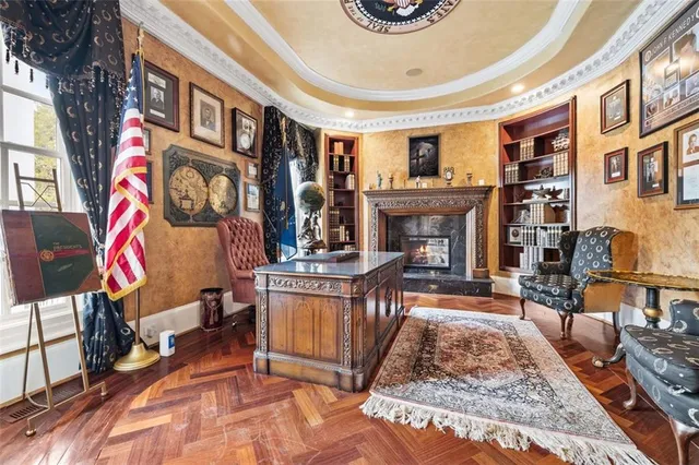 a kitchen with stainless steel appliances kitchen island granite countertop a refrigerator a stove a sink a dining table and chairs with wooden floor