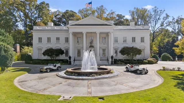 a view of a house with swimming pool and sitting area