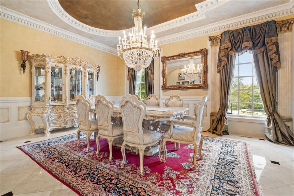 3687 Briarcliff Road Northeast Atlanta, GA 30345 - Photo 21 of 131 a view of a dining room with furniture a chandelier and wooden floor