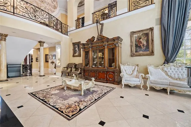 a living room with furniture a flat screen tv and a window