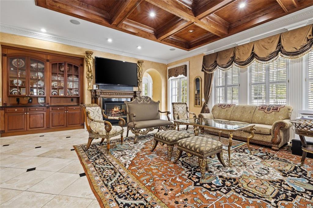 3687 Briarcliff Road Northeast Atlanta, GA 30345 - Photo 26 of 131 a living room with furniture a flat screen tv and kitchen view
