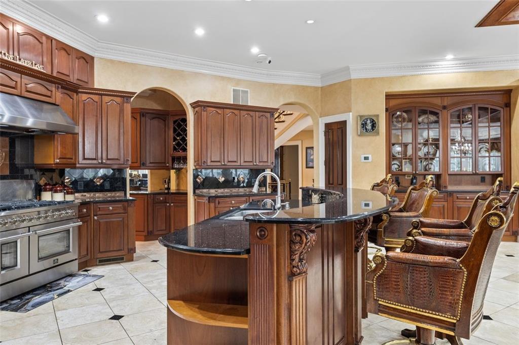 3687 Briarcliff Road Northeast Atlanta, GA 30345 - Photo 32 of 131 a kitchen with stainless steel appliances granite countertop a refrigerator and a stove top oven