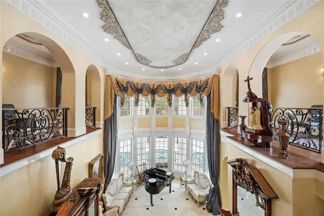 a view of a house with a yard and large trees