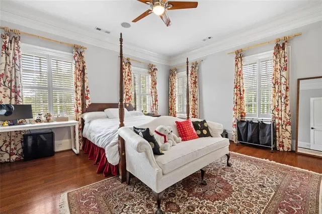 a living room with furniture a flat screen tv and a large window