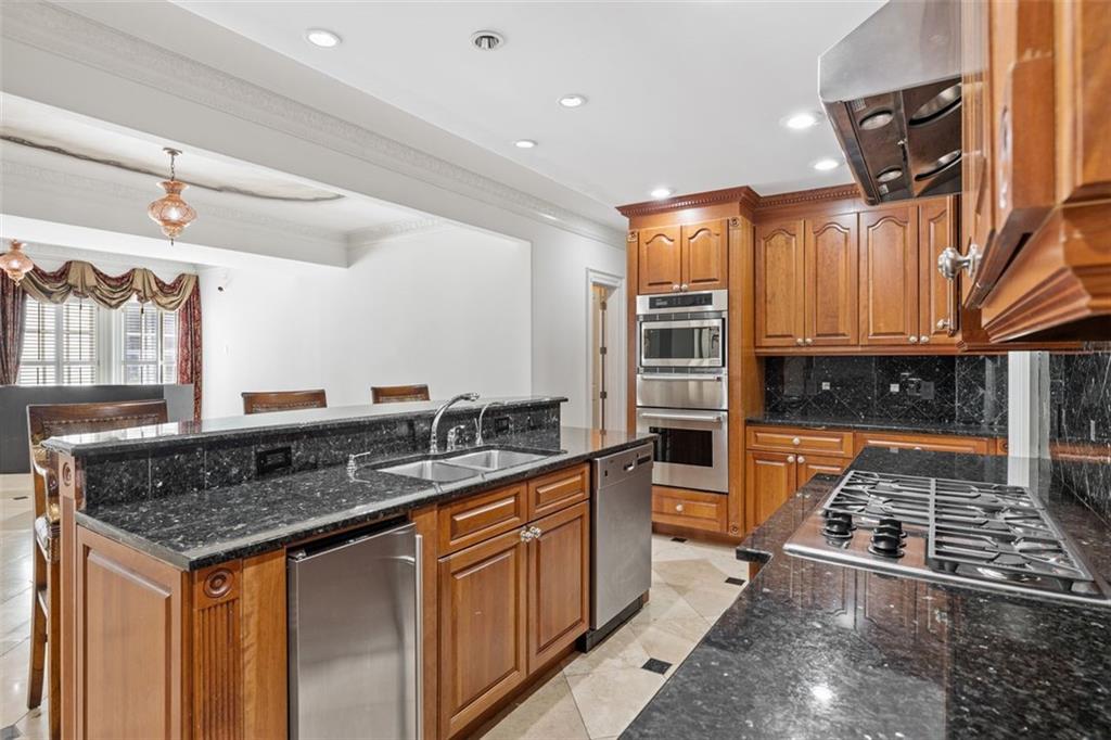 3687 Briarcliff Road Northeast Atlanta, GA 30345 - Photo 77 of 131 a kitchen with stainless steel appliances granite countertop a stove a sink and a refrigerator