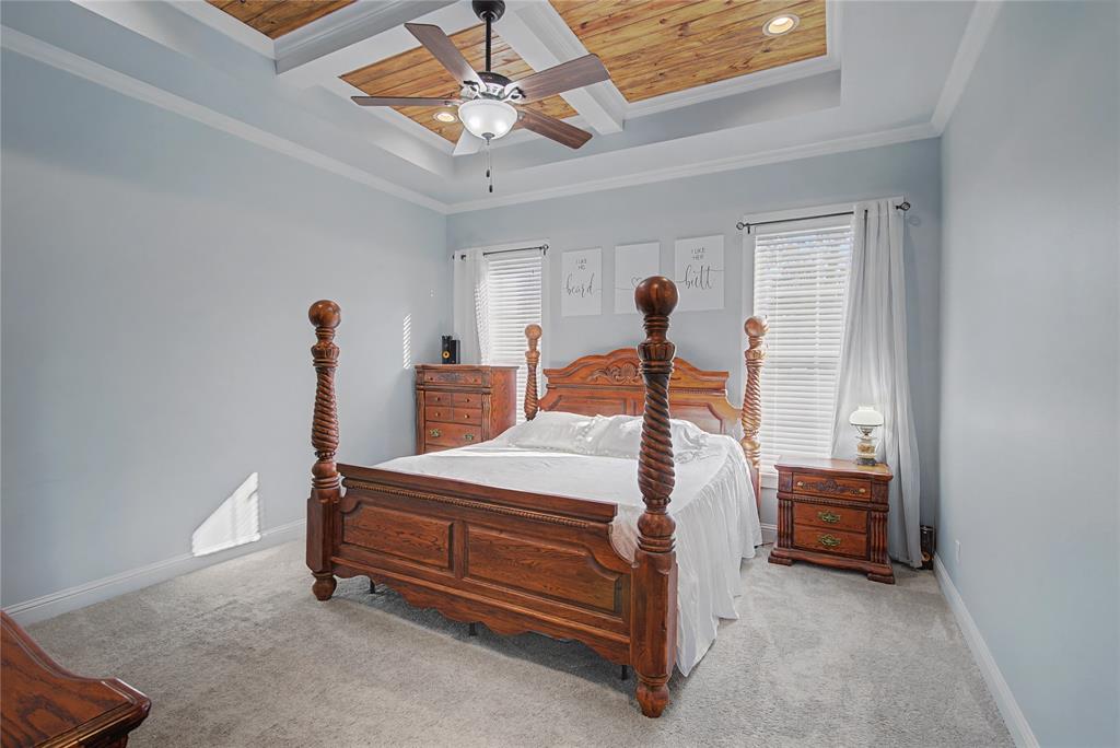 550 Ramsey Road Stonewall, LA 71078 - Photo 30 of 40 a bedroom with a bed and a chandelier