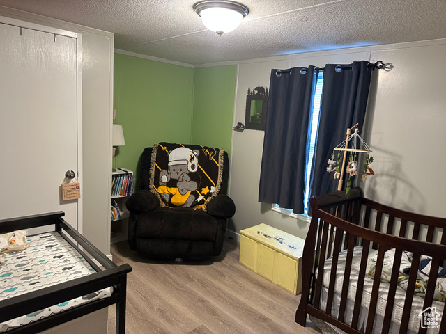 1375 West 500th North, Unit 95 Provo, UT 84601 - Photo 11 of 19 Bedroom with wood finished floors and a textured ceiling