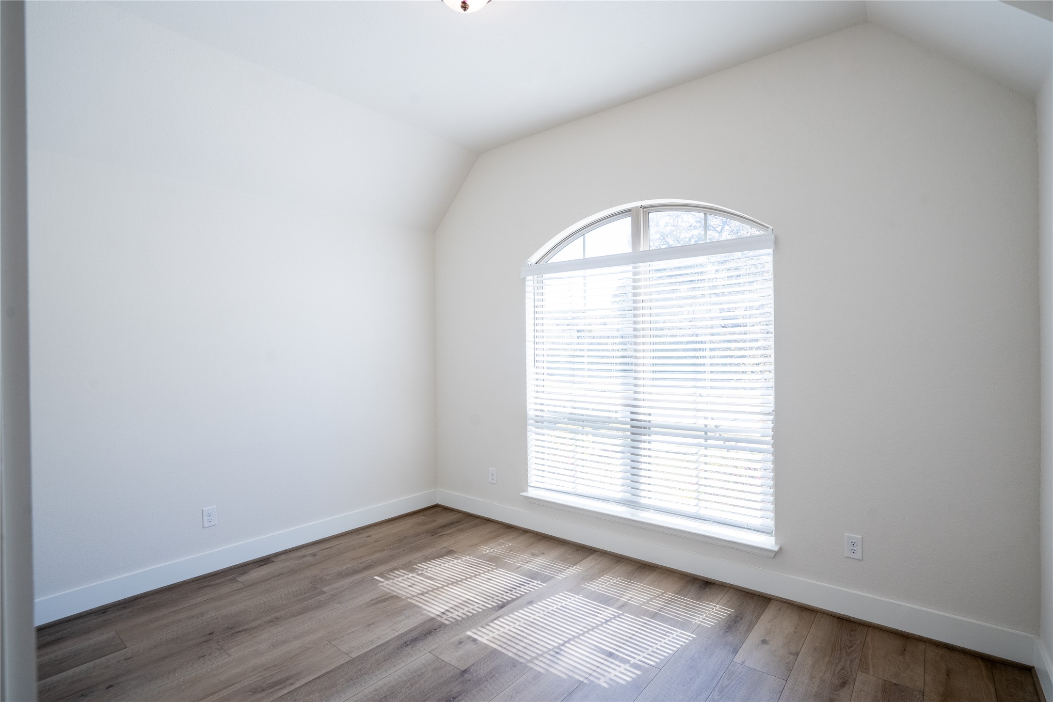 1309 Spring Gulch Lane Georgetown, TX 78628 - Photo 15 of 27 an empty room with wooden floor and windows