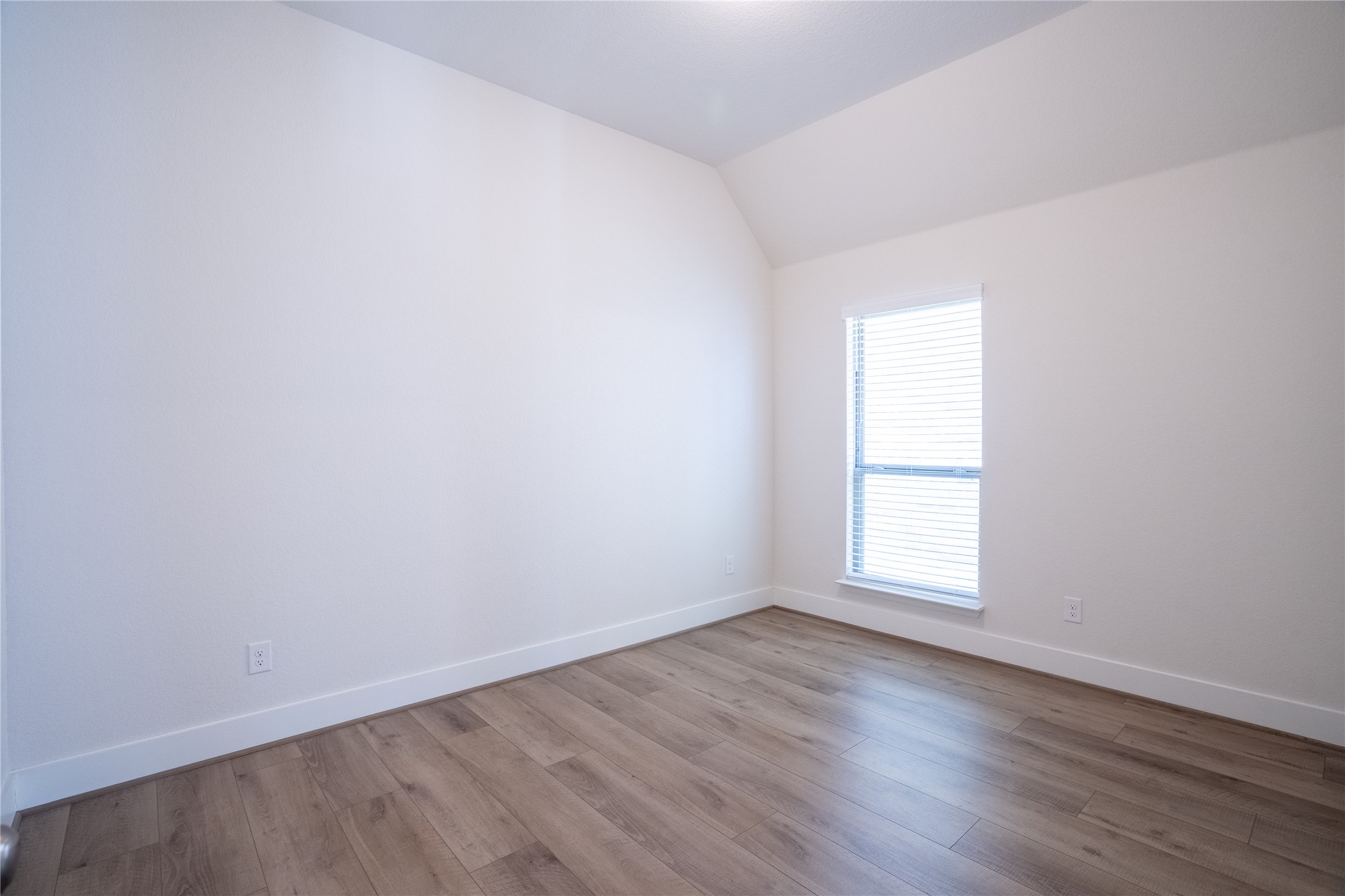 1309 Spring Gulch Lane Georgetown, TX 78628 - Photo 17 of 27 an empty room with wooden floor and window