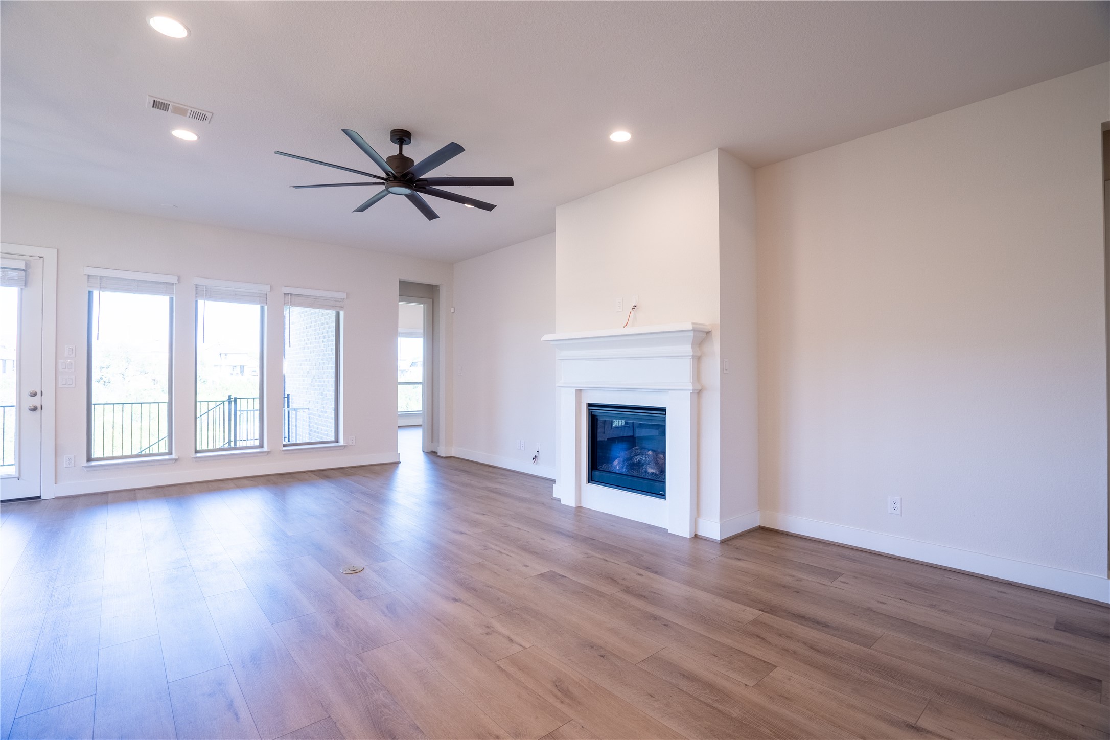 1309 Spring Gulch Lane Georgetown, TX 78628 - Photo 18 of 27 a view of empty room with wooden floor and fan