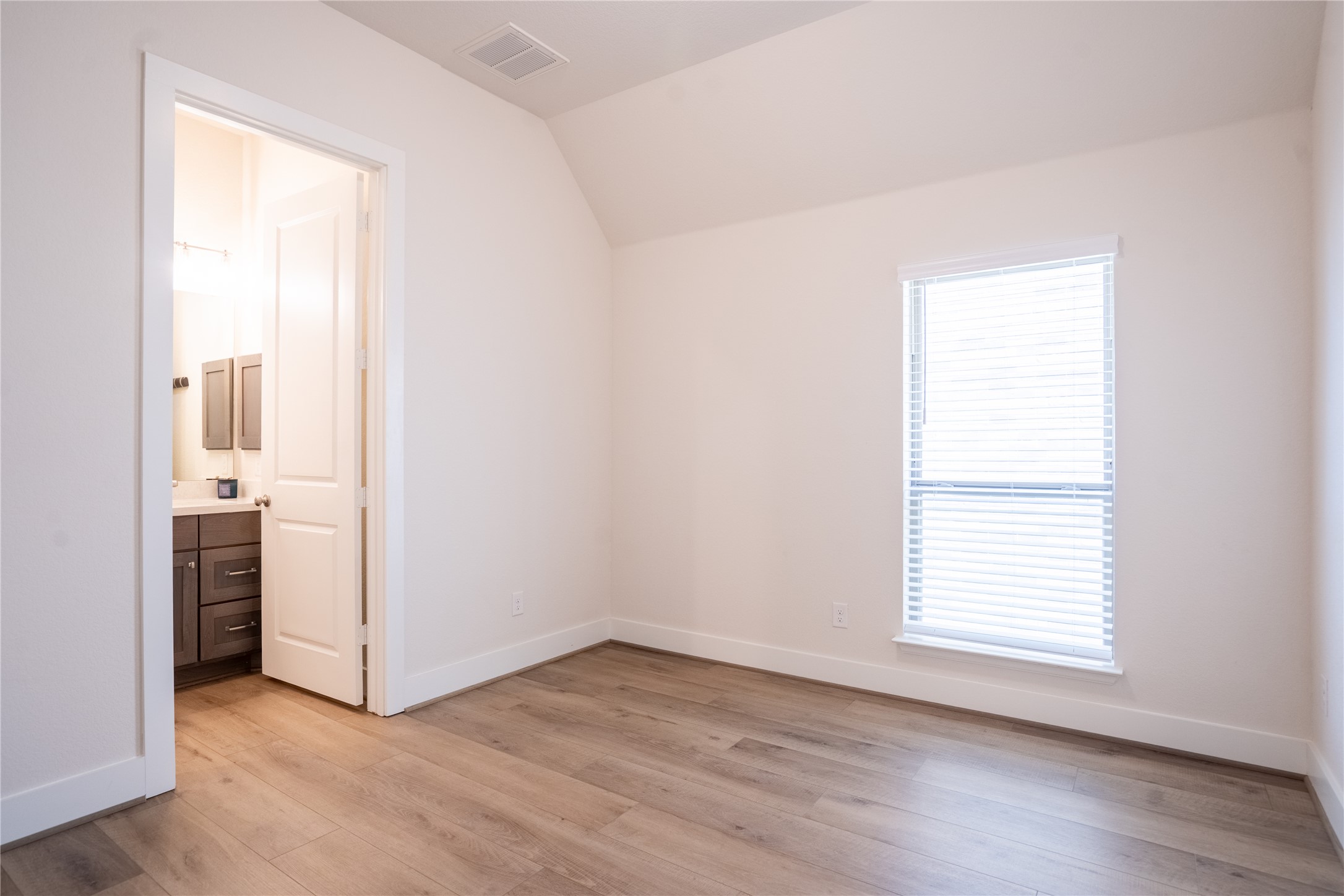 1309 Spring Gulch Lane Georgetown, TX 78628 - Photo 21 of 27 an empty room with wooden floor and a window