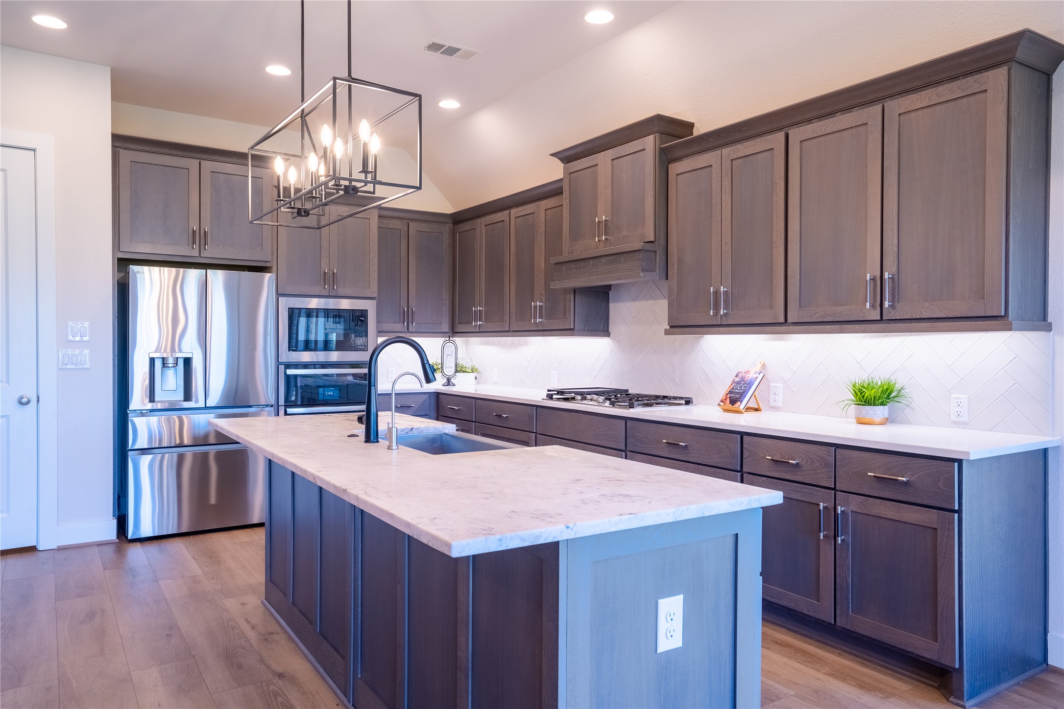 1309 Spring Gulch Lane Georgetown, TX 78628 - Photo 5 of 27 a kitchen with kitchen island granite countertop a sink a counter space appliances and cabinets