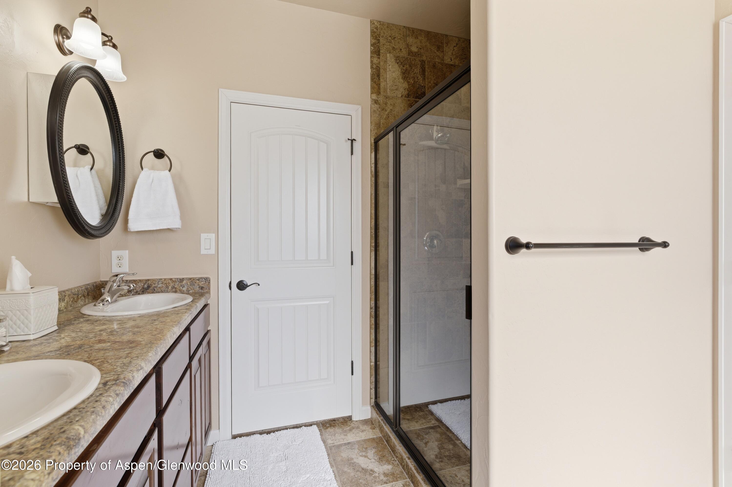 1081 20 Road Fruita, CO 81521 - Photo 11 of 43 a bathroom with a granite countertop sink and a mirror