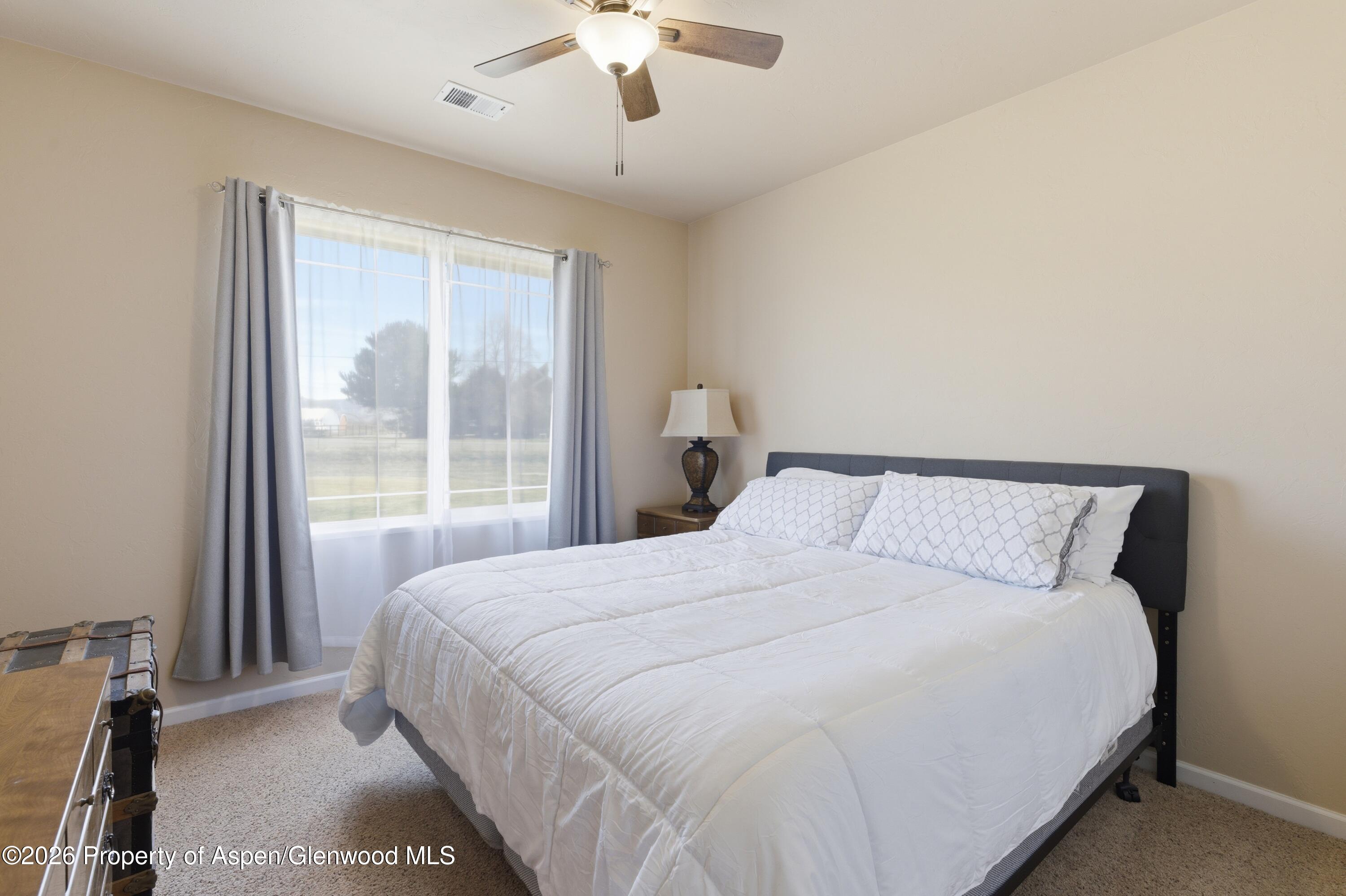 1081 20 Road Fruita, CO 81521 - Photo 15 of 43 a large bed sitting in a bedroom next to a window