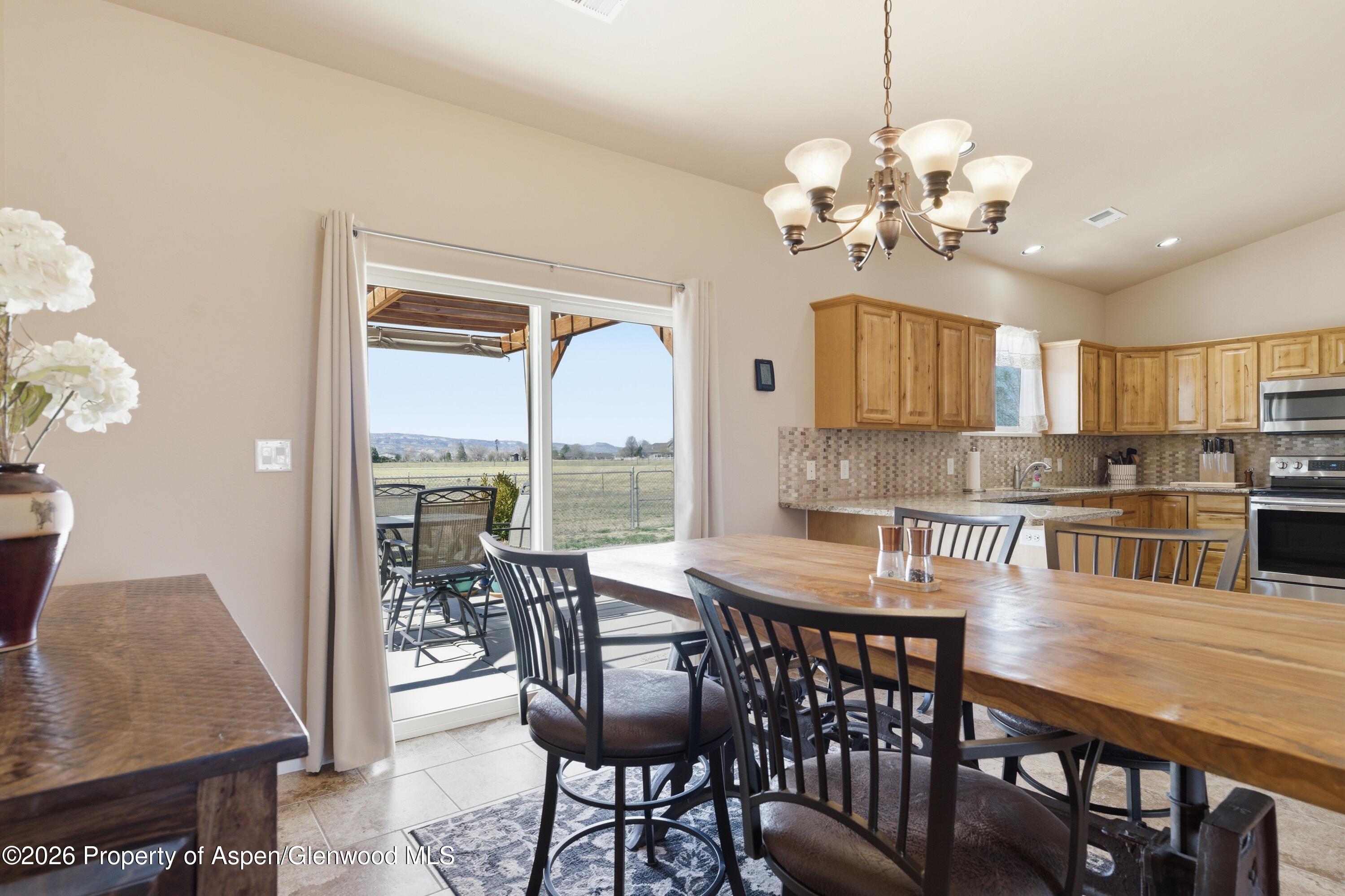 1081 20 Road Fruita, CO 81521 - Photo 4 of 43 a view of a dining room with furniture a chandelier and wooden floor