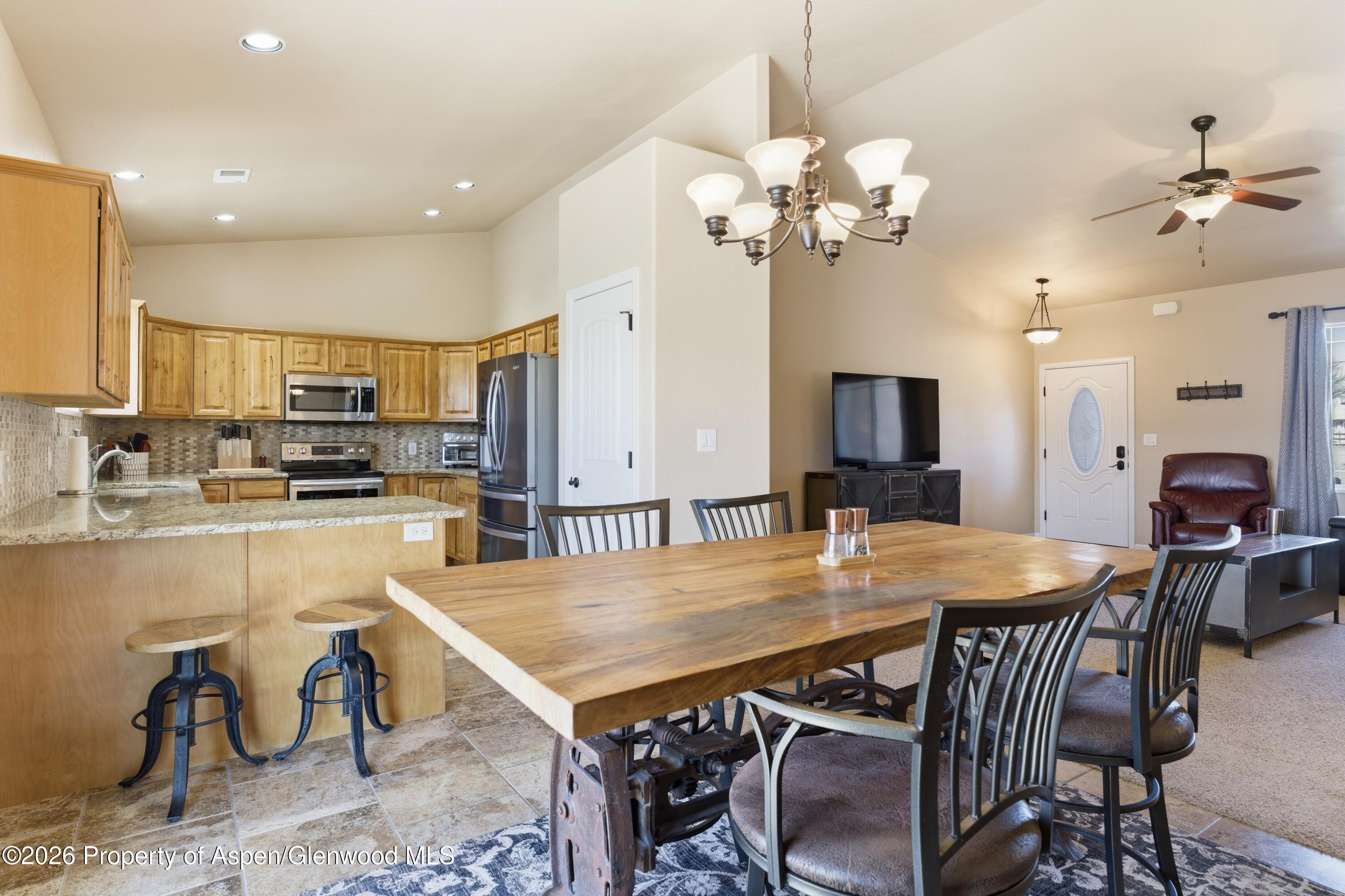 1081 20 Road Fruita, CO 81521 - Photo 6 of 43 a view of a dining room with furniture and a chandelier