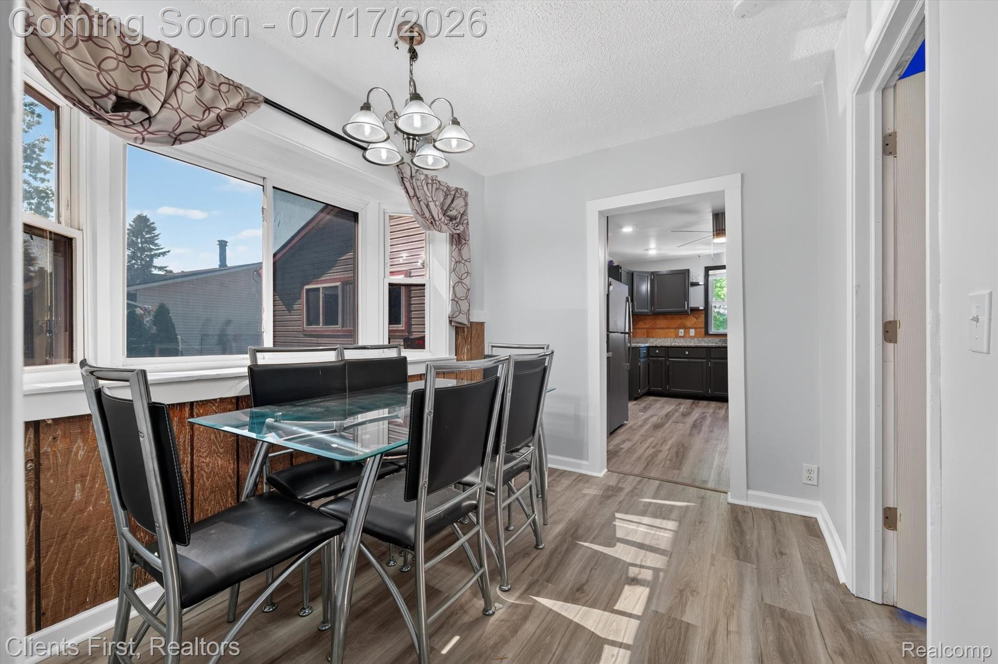 36852 Chase Street Romulus, MI 48174 - Photo 13 of 40 Dining area with light wood-finish flooring and a contemporary chandelier