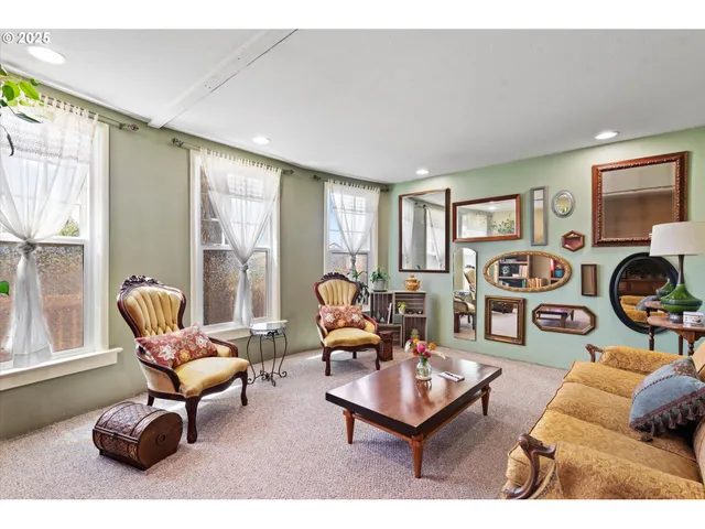 a living room with furniture a rug and a window