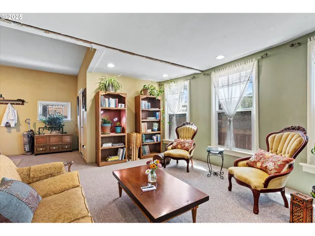a living room with furniture a rug and a large window