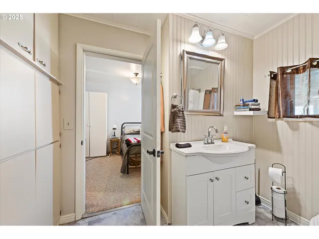 a en suite bathroom with a sink mirror and toilet
