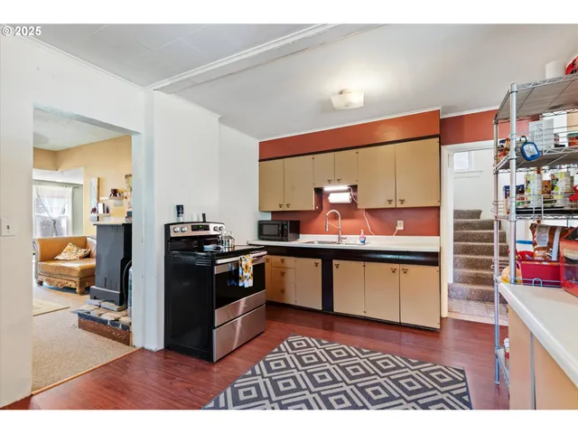 a kitchen with stainless steel appliances a sink and a refrigerator