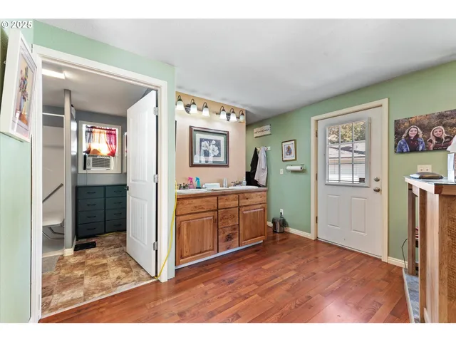 a kitchen with cabinets and wooden floor