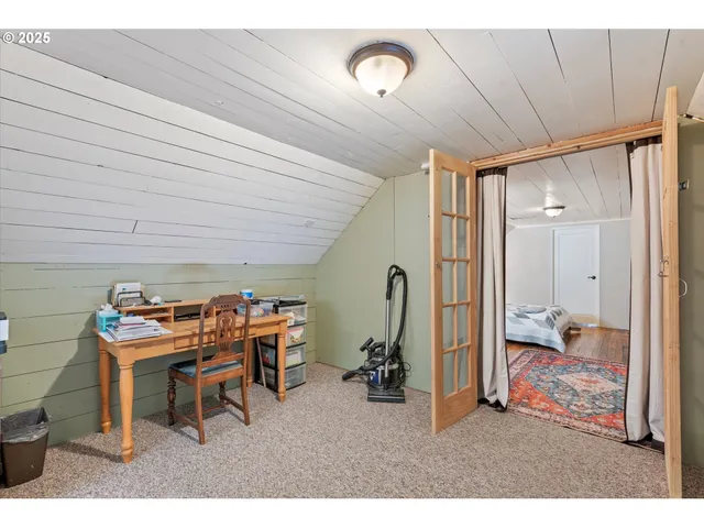 a room with furniture a air conditioner vent and a window