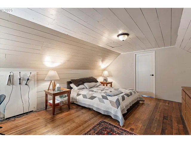 a bedroom with a bed and a table