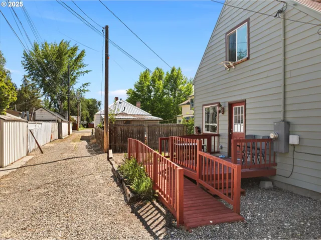 a view of a house with wooden fence and floor