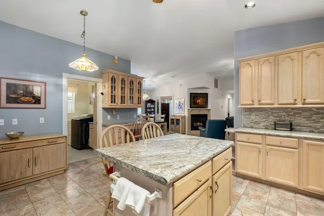 a view of a workspace with furniture and a flat screen tv