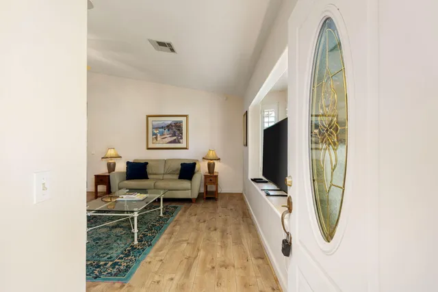 a living room with furniture fireplace and a view of kitchen