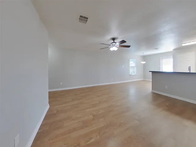 a view of a kitchen with a sink and a chandelier fan