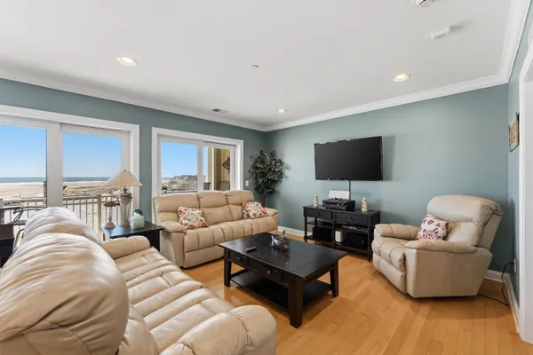 a living room with furniture flat screen tv and a couch