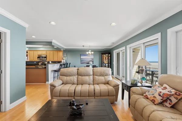 a living room with furniture and kitchen view