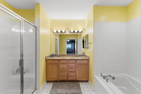 a spacious bathroom with a granite countertop sink and a mirror