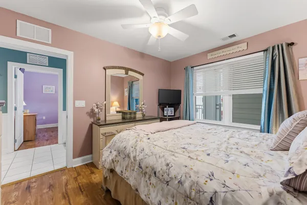 a bedroom with a large bed and dresser