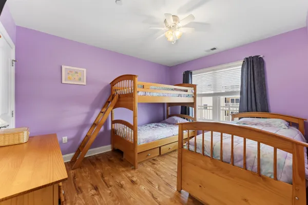 a bedroom with furniture and wooden floor