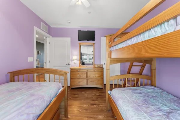 a bedroom with a bed and large windows