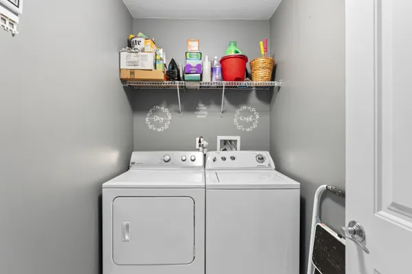 a view of storage and utility room with washer and dryer