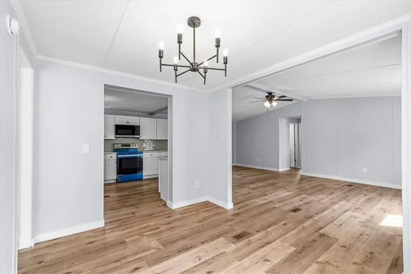 a view of a kitchen with a sink and a refrigerator