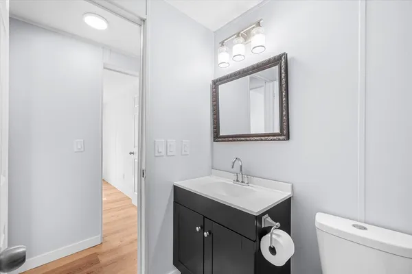 a bathroom with a toilet sink and mirror