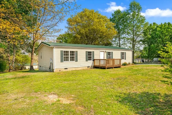 a house that has a big yard with wooden fence