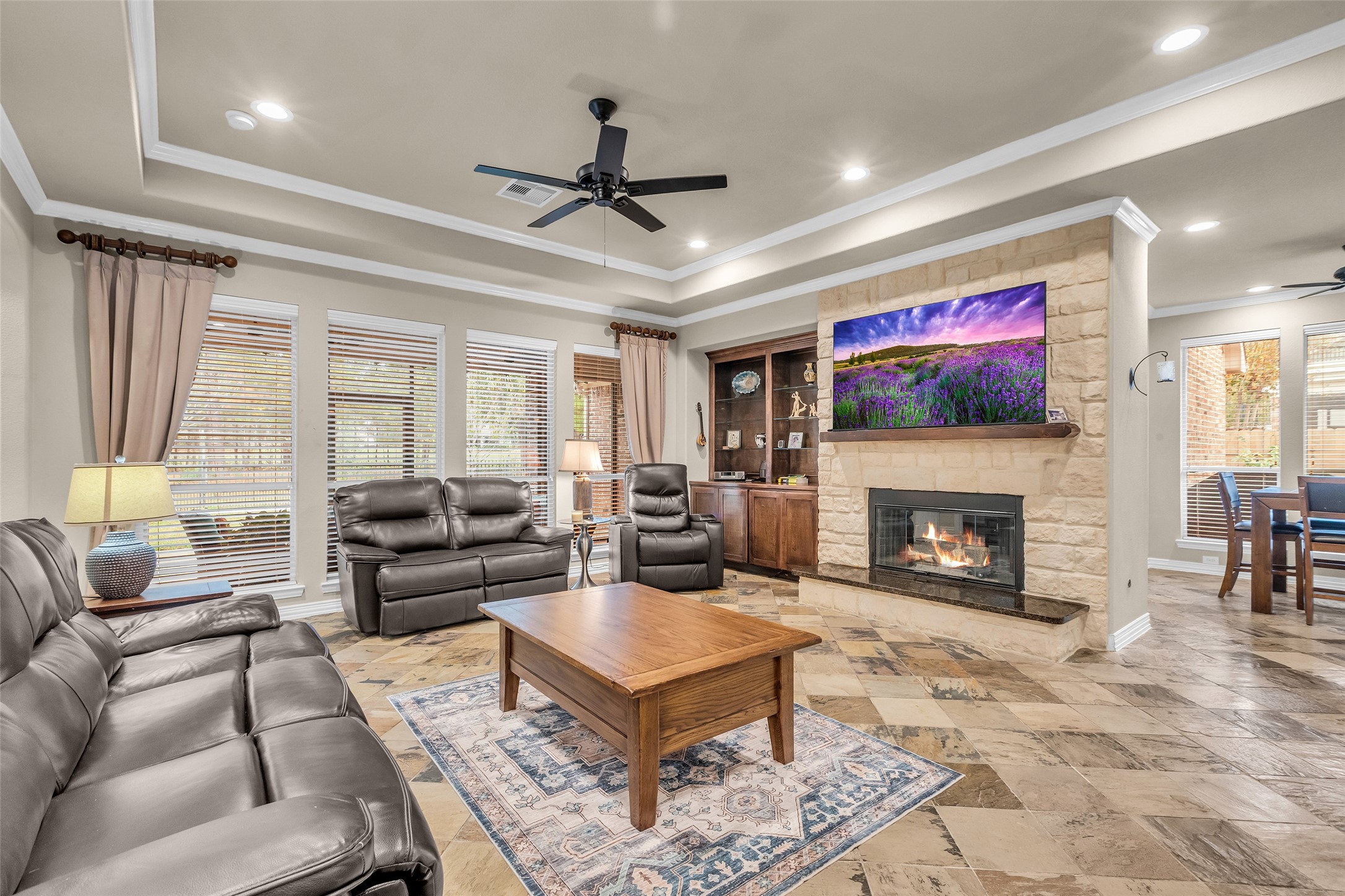1622 Beau Rivage Conroe, TX 77304 - Photo 22 of 37 a living room with furniture a flat screen tv and a fireplace