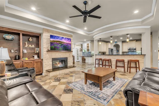 a living room filled with furniture and a floor to ceiling window
