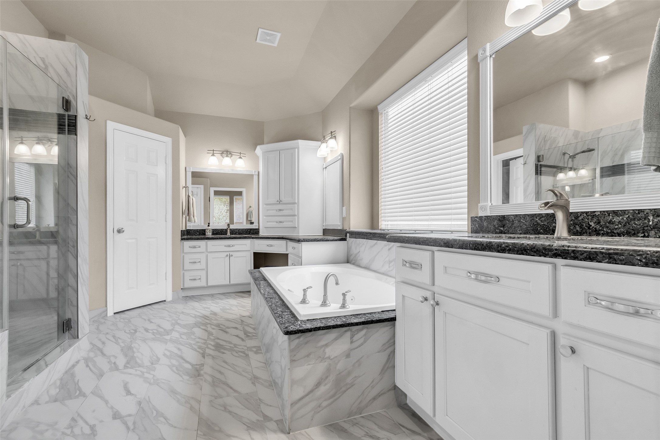 1622 Beau Rivage Conroe, TX 77304 - Photo 25 of 37 a bathroom with a tub a sink and a large mirror