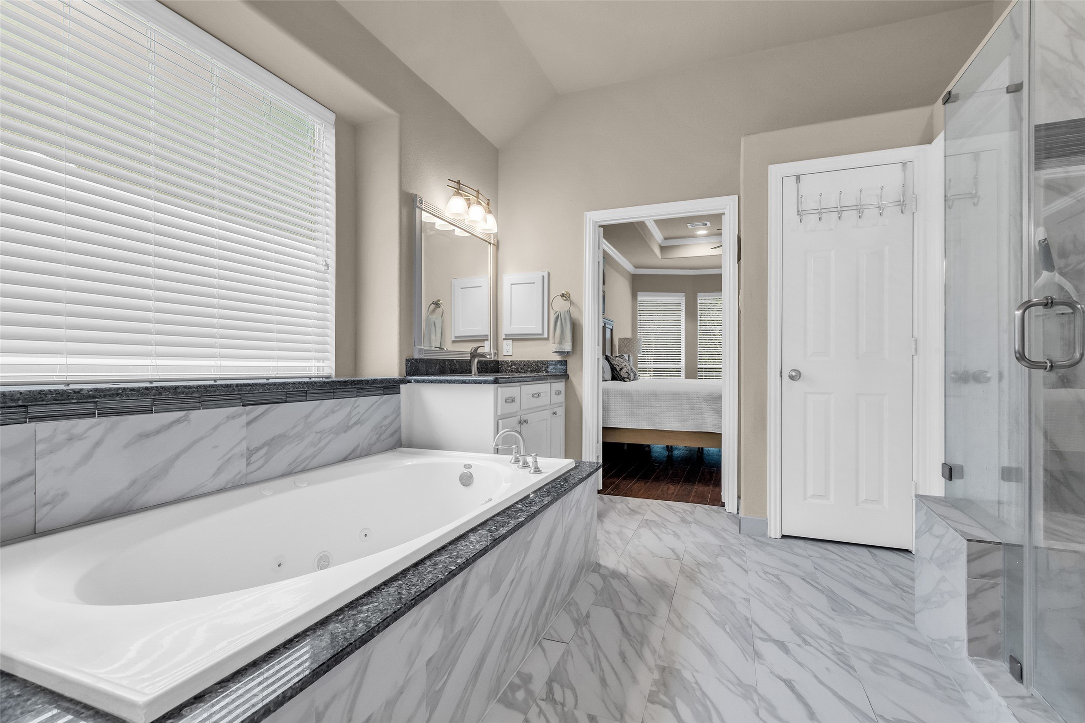 1622 Beau Rivage Conroe, TX 77304 - Photo 26 of 37 a bathroom with a bathtub and a shower