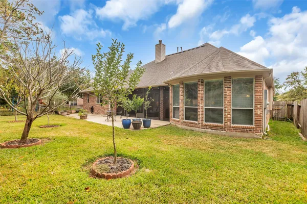 a bathroom with a tub a sink and a large mirror