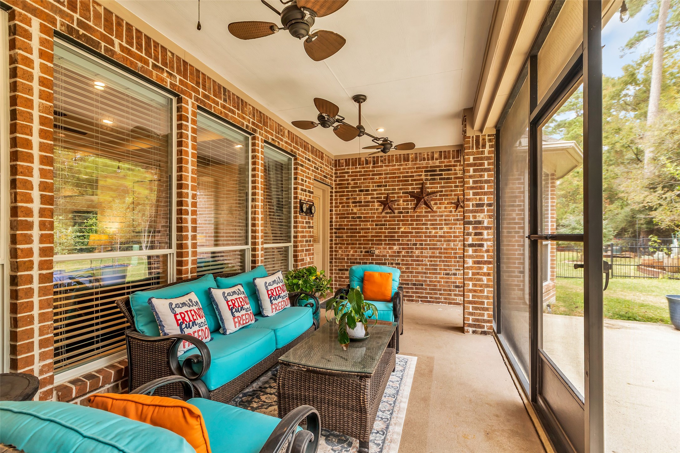 1622 Beau Rivage Conroe, TX 77304 - Photo 34 of 37 a living room filled with furniture and a floor to ceiling window