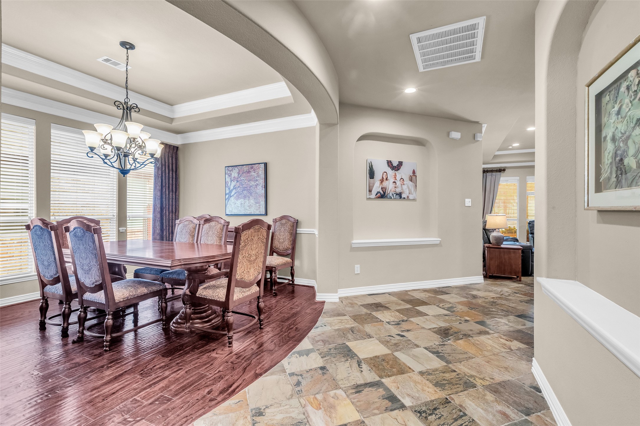 1622 Beau Rivage Conroe, TX 77304 - Photo 6 of 37 a view of a dining room with furniture a chandelier and wooden floor