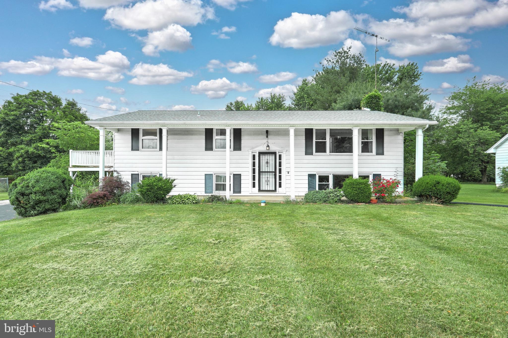 147 Mud College Road Littlestown, PA 17340 - Photo 1 of 43 a front view of a house with a garden